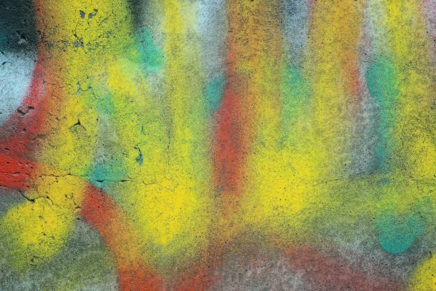 istock colored paint on a dirty concrete fence wall 1523038898