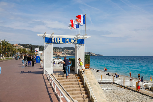 Nice, France - April 21, 2023: There are beaches along the Mediterranean Sea, some of them marked and fenced. Here you can see such a descent from the Promenade des Anglais to such a beach
