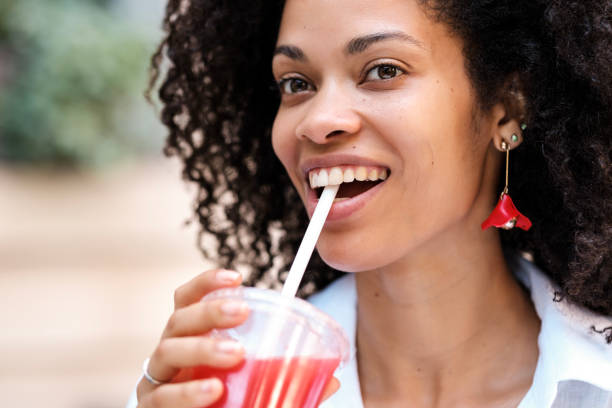istock Happy black woman drinking a strawberry juice.. 1523084362