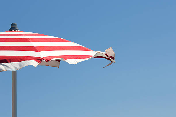 istock Red and white beach umbrella against blue sky 152308488