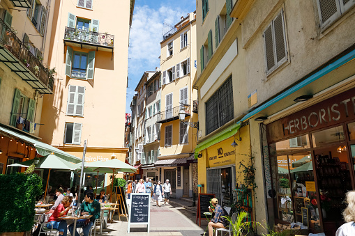Nice, France - April 25, 2023: Historical residential buildings in the old town. Both tourists and residents will find many restaurants, cafes and shops in the old part of the city