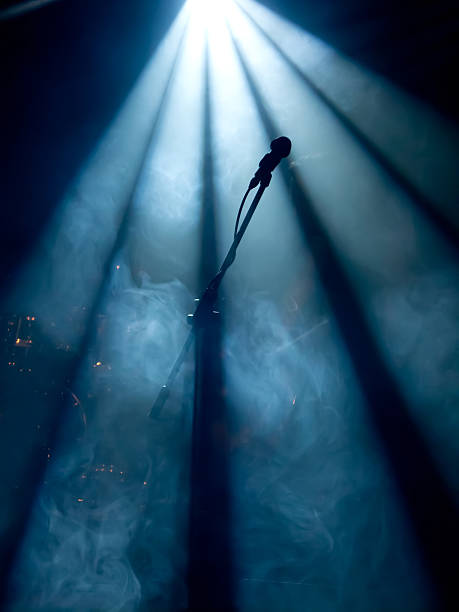Microphone on stage with stage-lights and fog stock photo