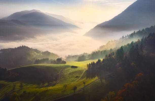istock Mountain landscape with hills low clouds green fields at dawn 1523131621