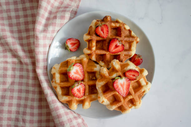 istock Waffles with strawberries on a light background 1523133174