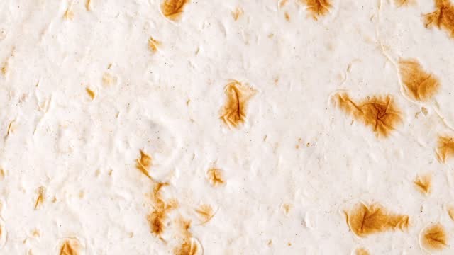 Pita tortilla close-up surface baked, rotating, turning, close-up, looped video