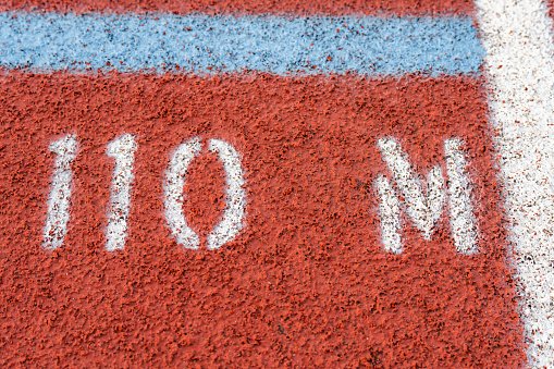 Close up of new red running track with 110 M text