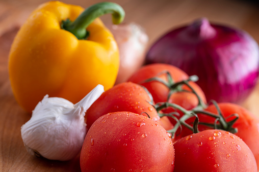 Fresh vegetables on a wooden cutting board.