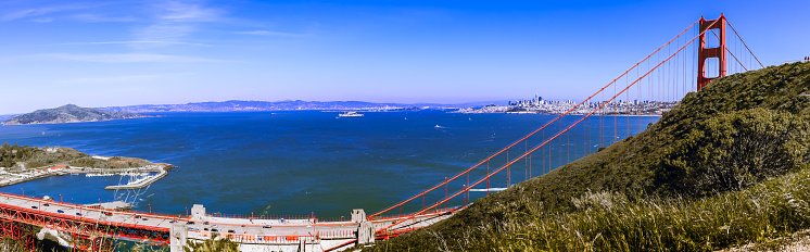 San Francisco,CA,USA. April 16, 2023 : Panorama view of San Francisco Bay, Golden Gate Bridge, and the city of Sausalito in Marin County from the top of a hill