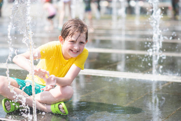 istock happy boy playing in dry fountain in summer 1523326593