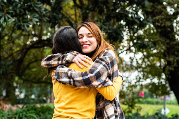 istock Young friends embracing on the puclic park 1523375223