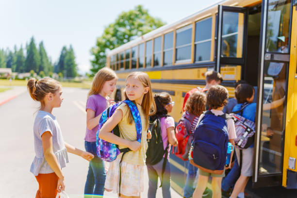 istock Elementary age kids boarding their school bus 1523376965