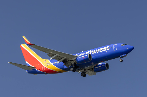 Portland, Oregon, USA - April28, 2023: A Southwest Airlines Boeing 737 lands at Portland International against a deep blue sky.