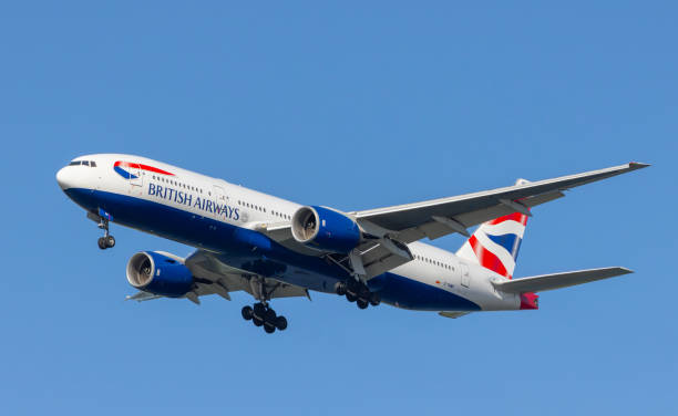 British Airways Boeing 777-200. Portland, Oregon, USA - June 4, 2013: A British Airways Boeing 777 comes in for landing at Portland International against a clear blue sky. british airways stock pictures, royalty-free photos & images