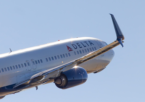 Portland, Oregon, USA - June 30. 2023: A Delta Airlines Boeing 737 climbs out of Portland International Airport on a sunny afternoon.