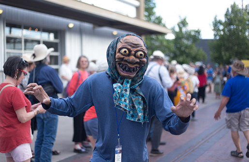 Santa Fe, NM: A Japanese artist wears a traditional mask at the Folk Art procession at the Santa Fe Railyard plaza. The procession kicks off the annual International Folk Art Market (IFAM), where folk artists from over 50 countries participate.