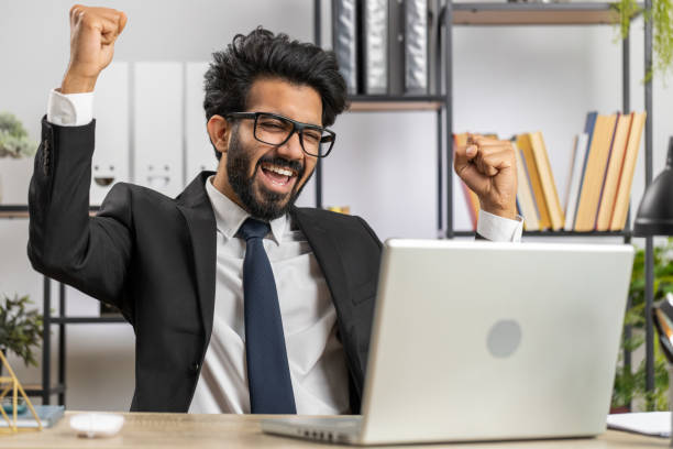 istock Business man winner working browsing typing on laptop at office celebrate big lottery win good news 1523654961