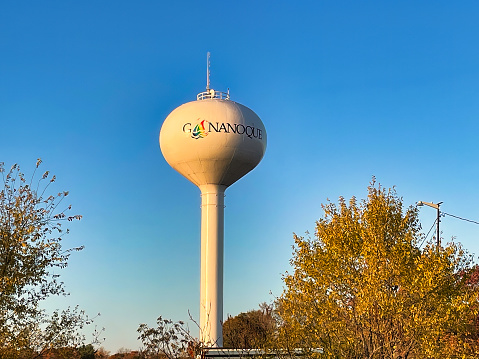 gananoque, canada - 22 October 2022 : a classic water tower for the pressure in the public water system with the name of the town on it