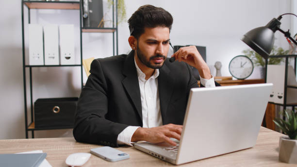 istock Businessman working on laptop wearing headset, call center support service operator office helpline 1523678283