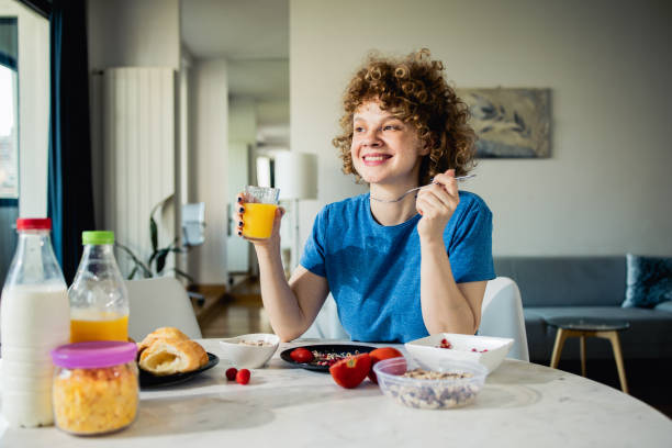 istock Happy young woman enjoys breakfast at home 1523679846