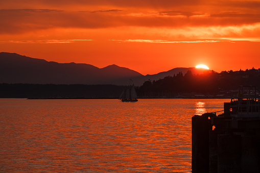Seattle, USA - Jun 26, 2023: Sunset over Elliott Bay on the waterfront with the Seattle Tall Sailing Ship The Bay Lady.