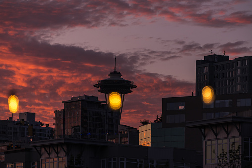 Seattle, USA - Jun 7, 2023: Late in the day a vivid sunset over Elliott bay from pier 62.