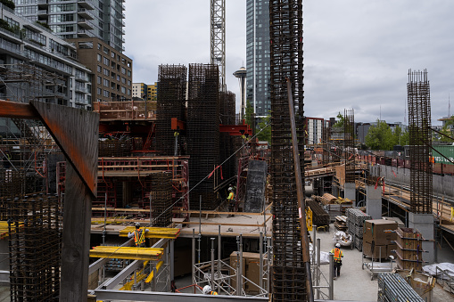 Seattle, USA - May 30th, 2023: Construction  in Belltown with the Space Needle in the background late in the day.