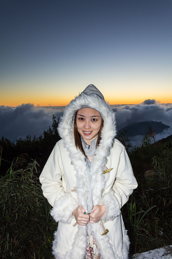 A young women model posing on top of Alishan mountain during sunset