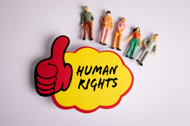 istock Human Rights. Sticky note with text and miniature human figures on a white background 1523810904