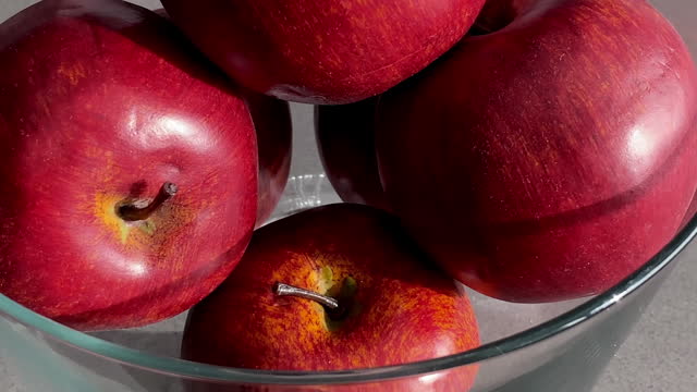 Plastic apples inside glass container