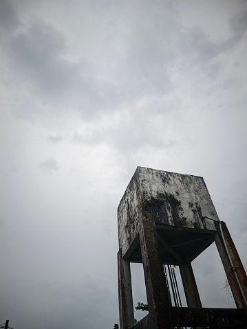 water reservoir made of concrete cement with a cloudy sky background