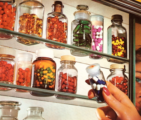 Woman's Hand in Medicine Cabinet
