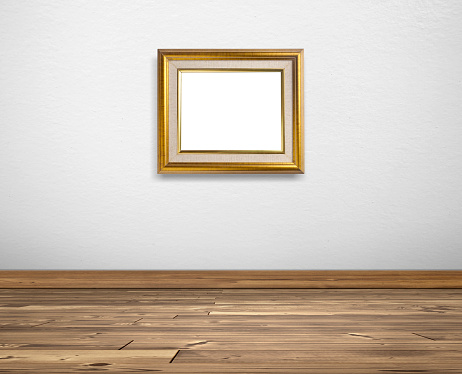 Golden picture frame on white walls and wooden floors