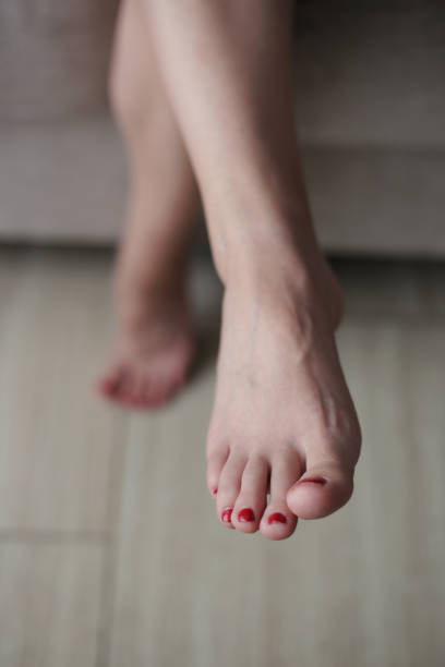 istock Female feet with red toe nails 1524113974