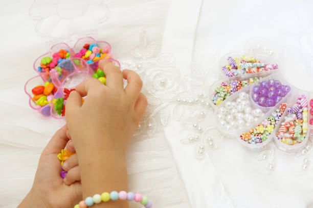 istock Set of multi-colored beads for needlework, child making jewelry at home. Easy and creative craft for children and teenagers. Making jewelry 1524135916