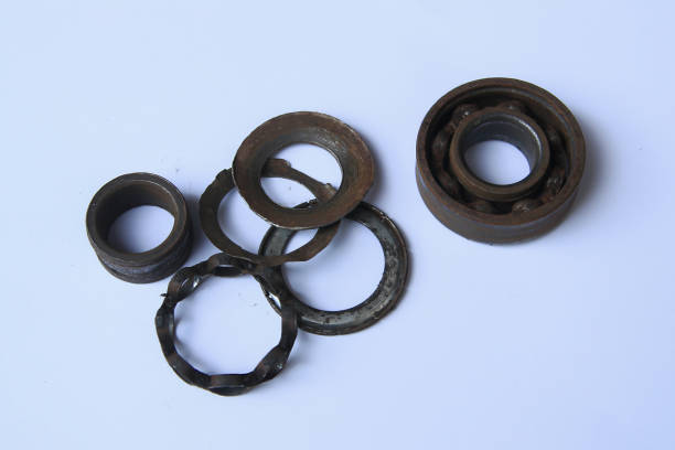 istock Old rusty bearing on white background. Old broken bearings rusted and disassembled into many parts. Old rust iron ball bearing disintegrated. Close-up view 1524143615