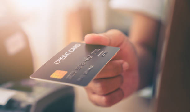 istock Customer holding credit card for payment on card reader machine to owner at restaurant. 1524226263