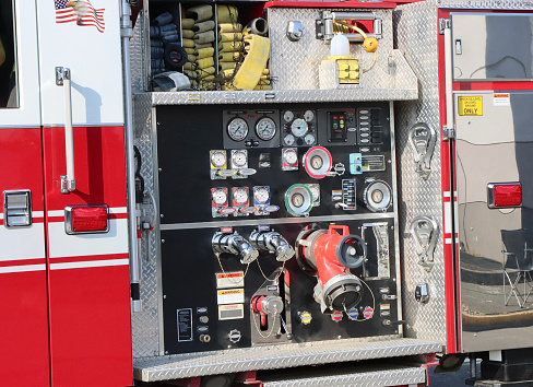 Firefighter protection gear, helmet, gloves on the bumper of the fire truck