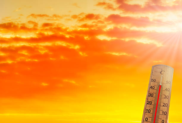 istock Thermometer on background of abnormally colored clouds. 1524275984