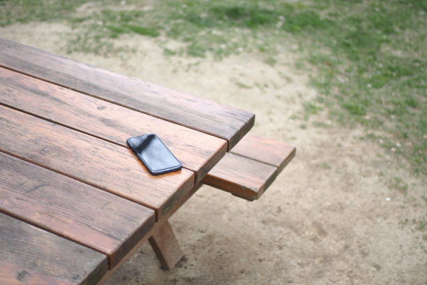 istock forget smartphone on a park bench, lost smart phone 1524288786