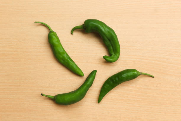 istock Fresh green chili pepper on wooden background 1524308203