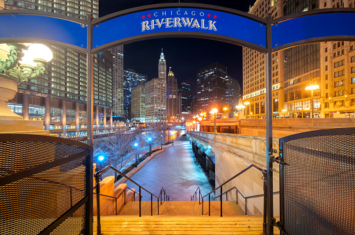signboard of Chicago Riverwalk sign at twilight with chicago city background