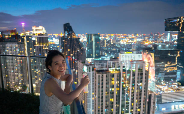 istock happy asian with cityscape skyline view at night 1524315015
