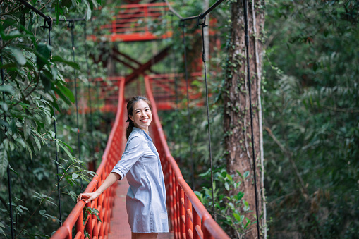 Modern tourist Asian travel tropical foresy bridge adventure happiness moment Botanic Garden at trang thailand