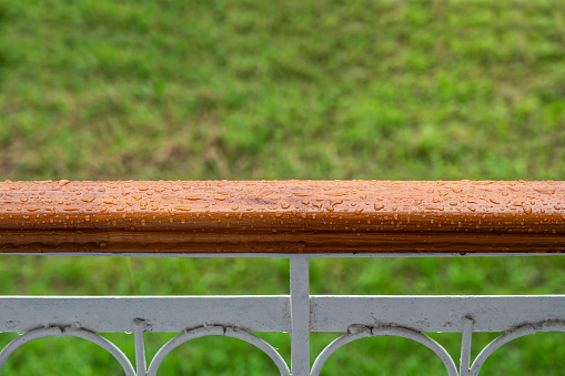 The balcony railing with rain drops. Background for inspiration and creativity, mood board.
