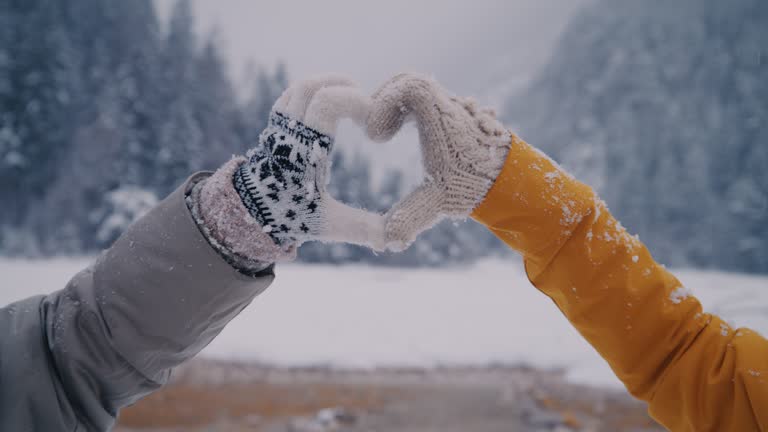 SLO MO Couple connects their hands together in the shape of a heart