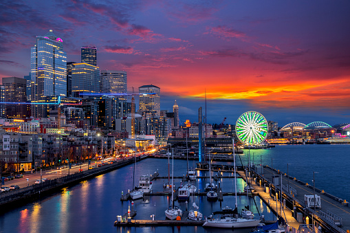 Beautiful view of Seattle waterfront and skyline at blue hour. Marina at pier 66, the great wheel, ferris wheel, Travel and urban architecture background.