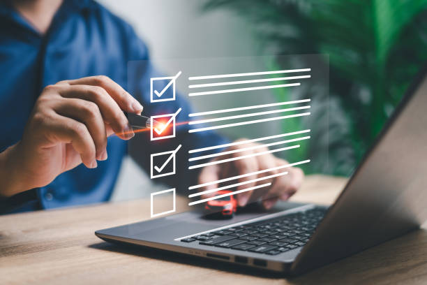 istock Digital checklist and document management with car insurance  concept, Businessman using laptop making a correct mark on check box on online surveys document insurance form and quality warranty 1524491694
