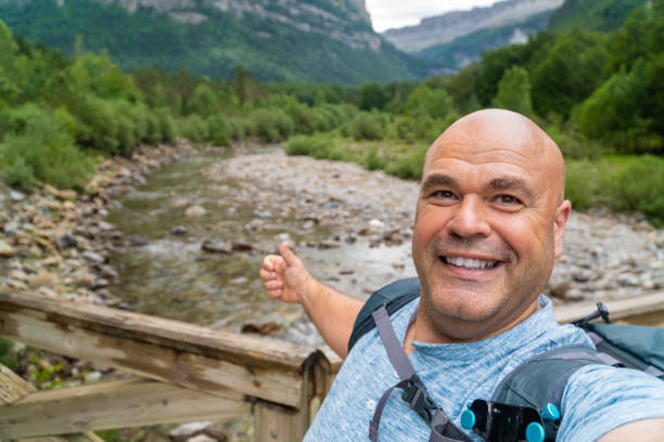 istock Happy hiker man takes a selfie with a river on the background 1524499627
