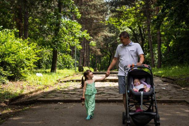 istock The father is happily walking with his daughters. 1524555985