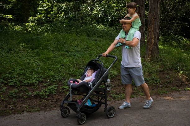 istock Father walking in the park with his daughters. 1524556006